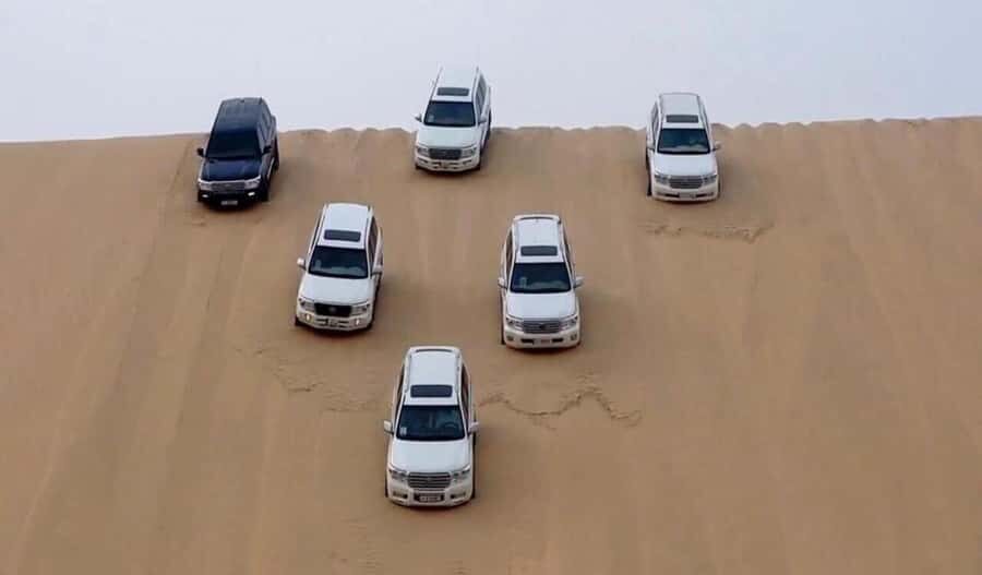 Desert Safari, Dunes Ride, Sand Boarding & Inland Sea Tour - Stop 1: Sealine Beach Resort for tea, photos, and camel time